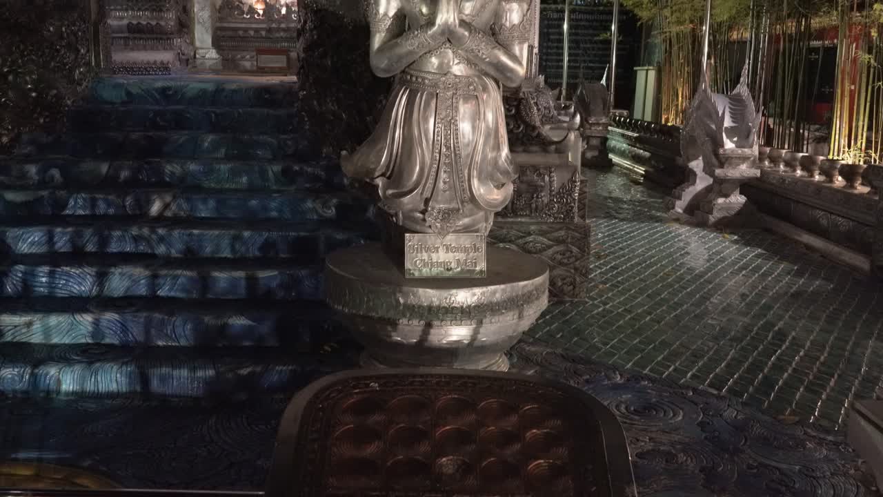 Chiang Mai,Tilt up slowly from a distance,outside of the Famous Silver Temple,Wat Si Supan at night.