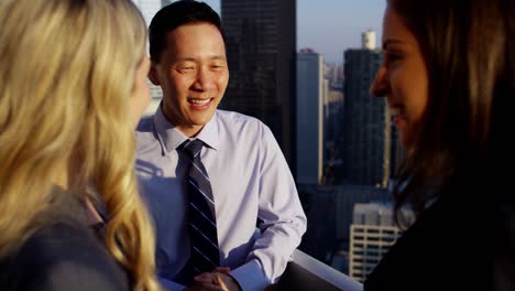 multi ethnic management team meeting on city rooftop