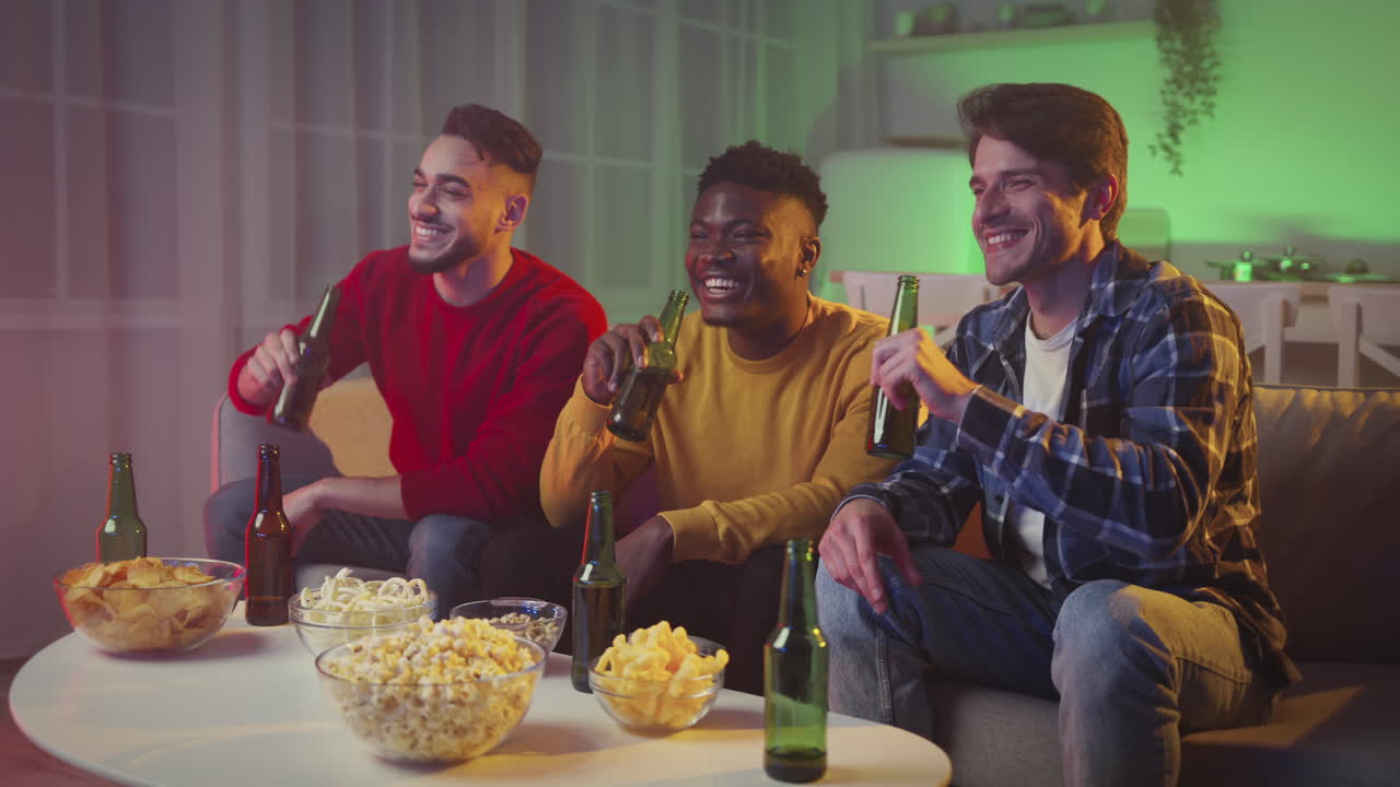 Friends Enjoying Drinks and Watching TV