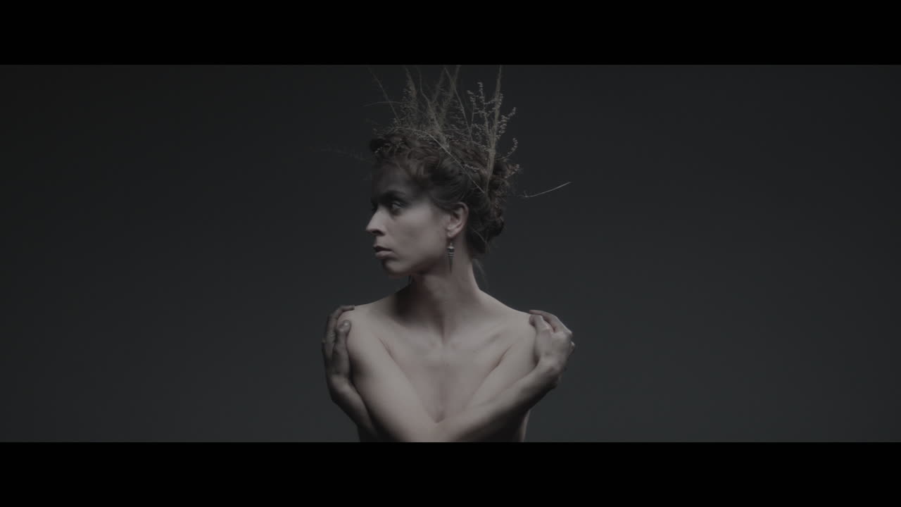 A woman dressed as mother nature turns her head