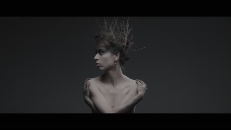 a woman dressed as mother nature turns her head