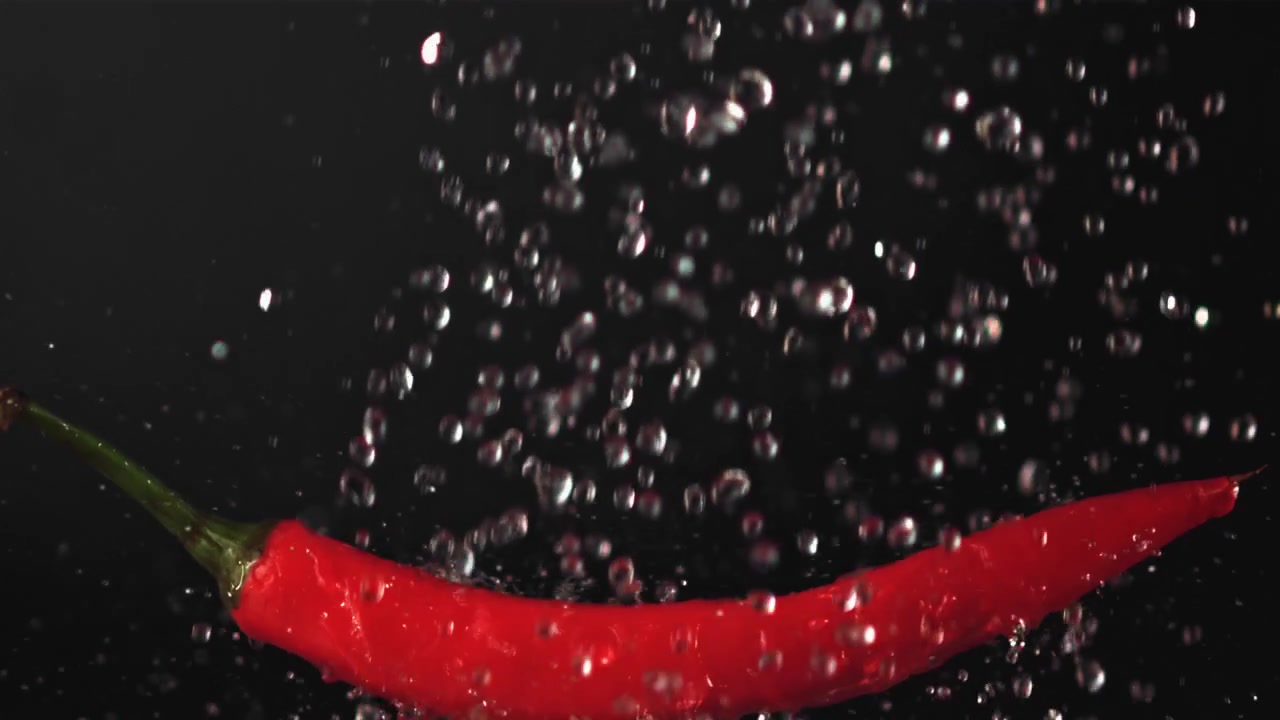 Fresh Red Chili Pepper with Water Drops on Black Background