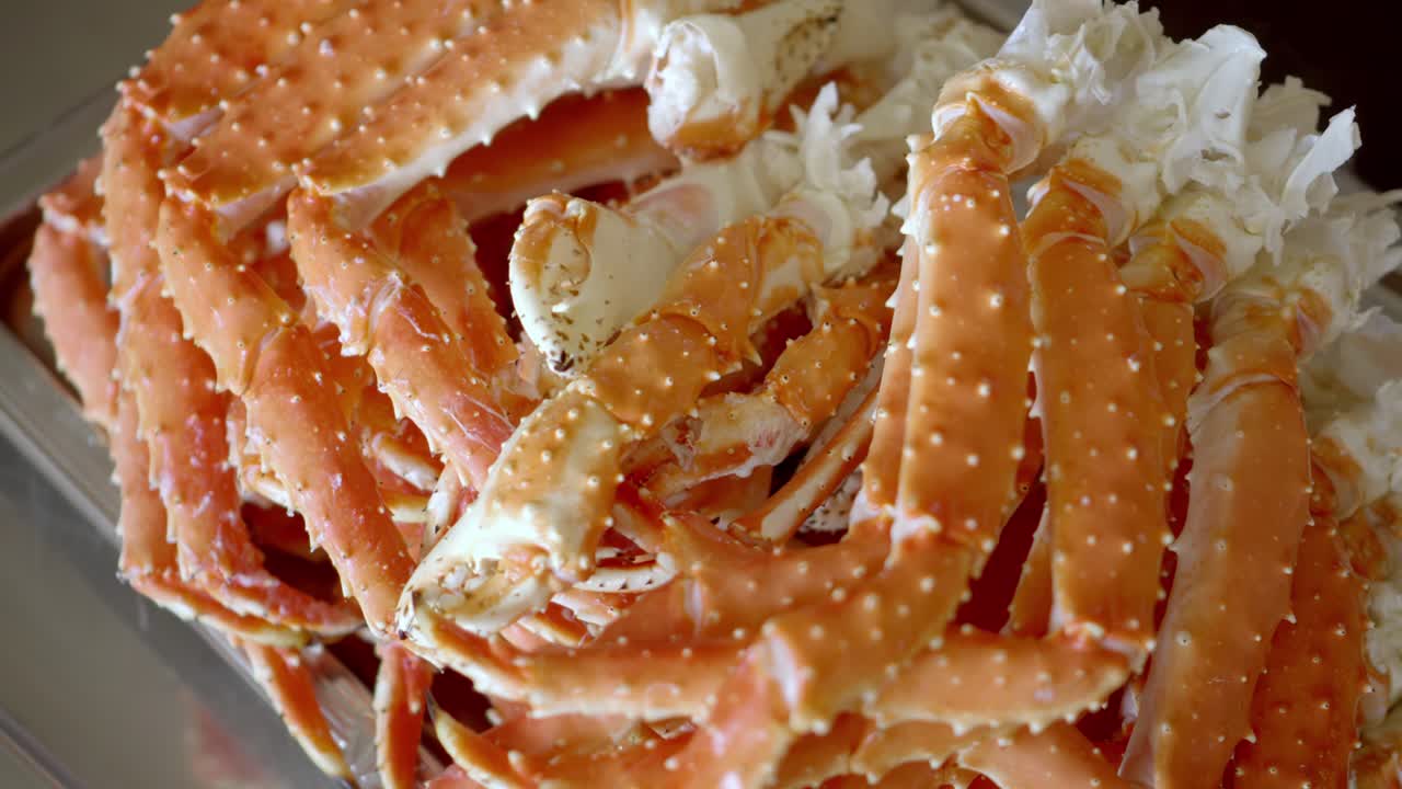 Freshly cooked crab legs piled together, showcasing seafood texture