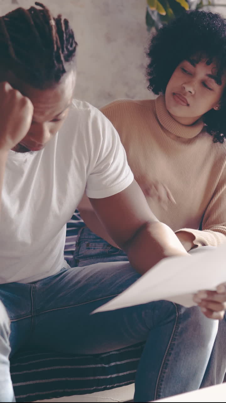 Young Black Couple Discussing Financial Documents with Concern