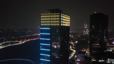 city skyline at night with illuminated skyscrapers