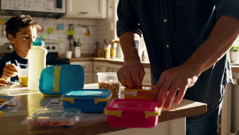 father preparing lunch for children