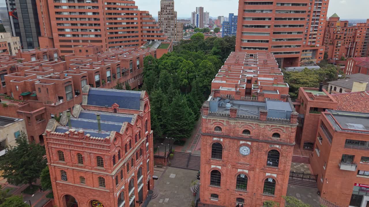 Aerial view of Bogota cityscape, showing red brick buildings and greenery