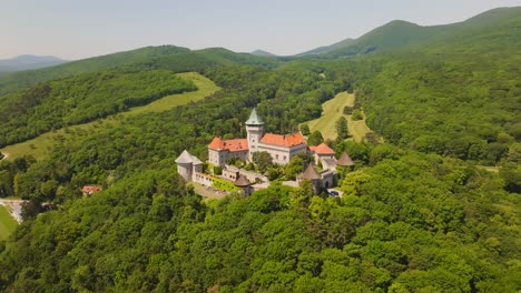 Aerial-view-of-Smolenice-Castle-located-in-the-green-forest-of-Little-Carpathians-mountains,-Slovakia