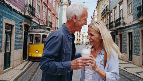 happy senior couple enjoying coffee in lisbon