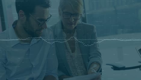 animation of data processing over two diverse businessman and businesswoman discussing at office
