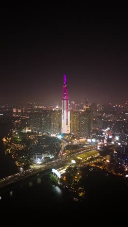 vertical zoom in aerial view of the landmark 81, the tallest skyscraper in ho chi minh city (saigon), vietnam. in the background is the unique cityscape and skyline of the city.