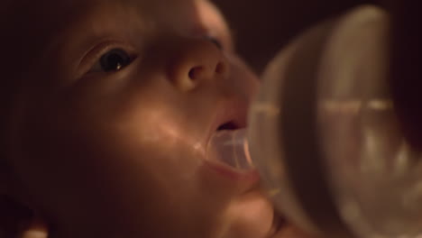 mother giving water to the baby