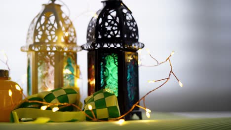 arabic lantern and ribbon ketupat on the rack by window