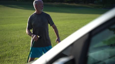 Crazy-man-washing-car-while-doing-the-dance-flossing-while-spraying-car-in-slow-motion