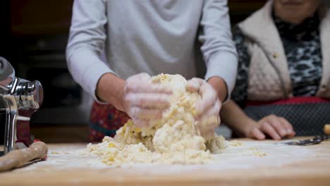 crop woman preparing dough at table in kitchen