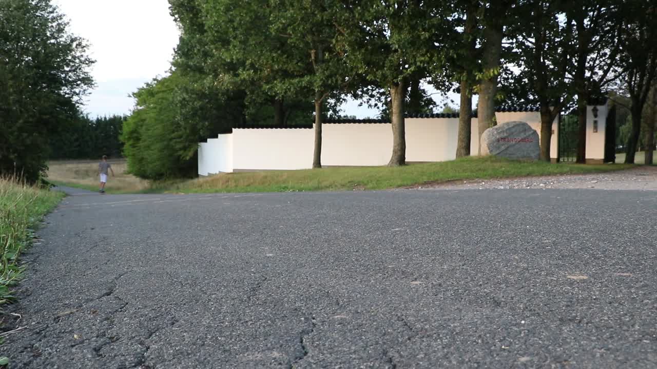 Guy skating by on pennyboard.