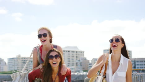 three friends having fun on a pier