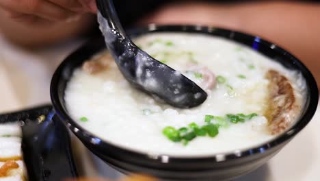 savoring a bowl of rice porridge