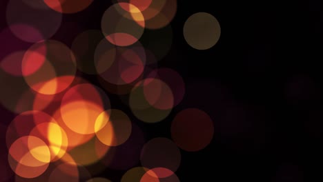 partículas de brillo de luz dorada bokeh loopable en fondo de bucle negro