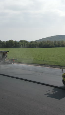 asphalt paving with heavy machinery on a road construction site