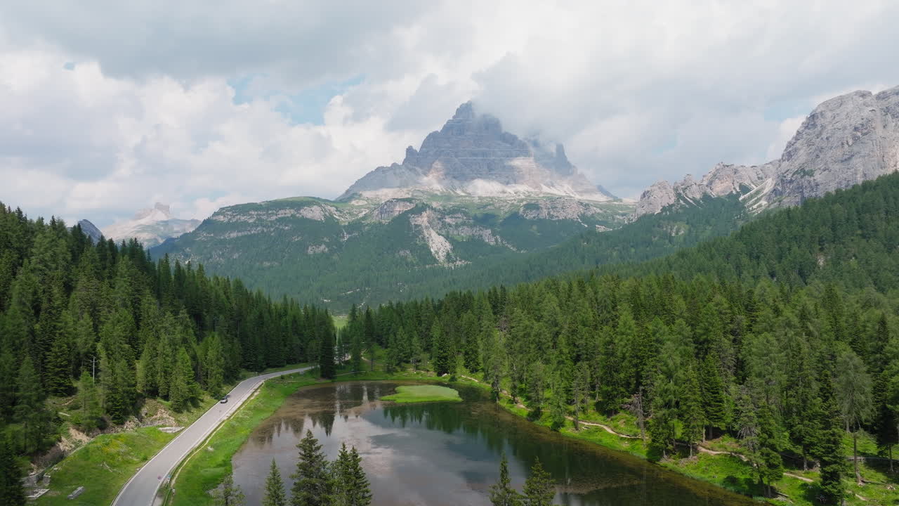 Aerial establishing of Lago di Misurina with majestic Dolomite peaks and surrounding forest