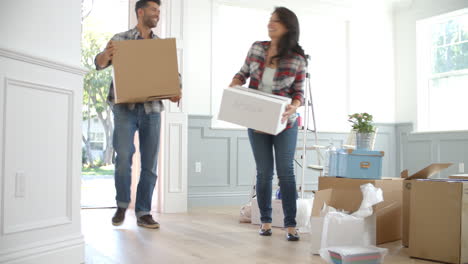 slow motion shot of hispanic family moving into new home