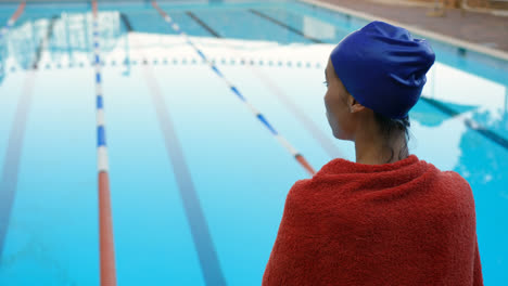 female swimmer standing near swimming pool 4k