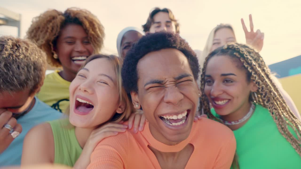 Smiling crazy multi-ethnic people taking selfies during sunset