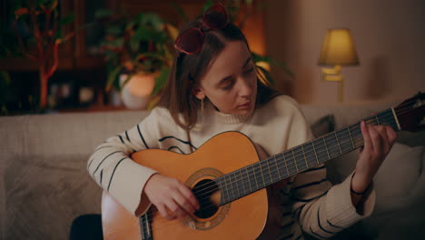 woman playing guitar writing song composing music