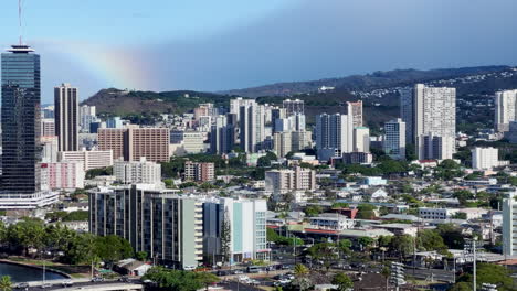 rainbow over skyline of honolulu, hawaii