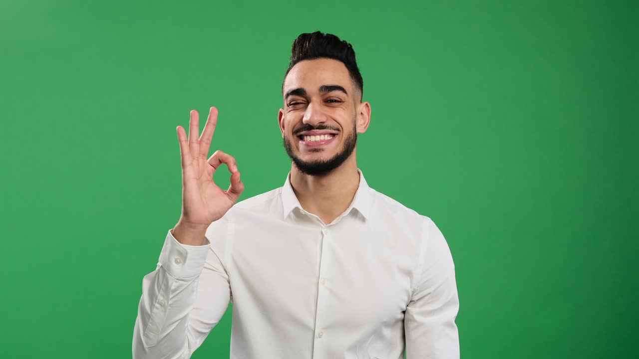 Young businessman showing ok gesture with hand