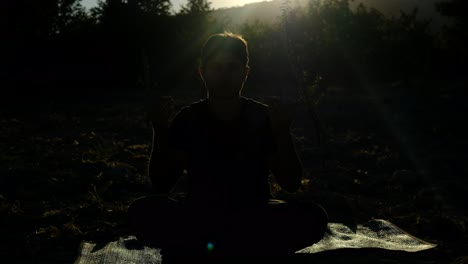 silhoutte young praying in garden