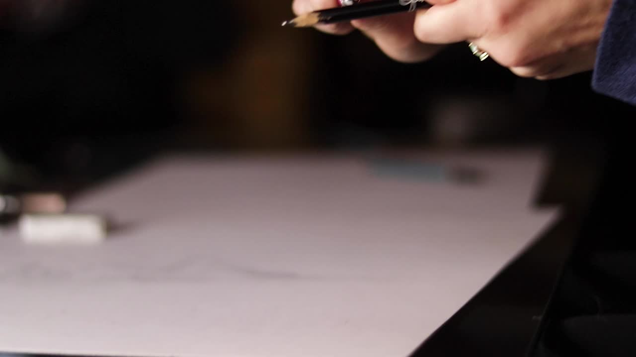 Mano che affila manualmente una matita in primo piano