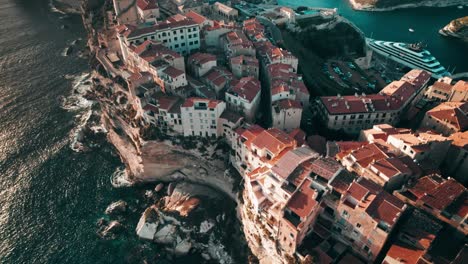 aerial, drone flying above bonifacio at sunset, corsica