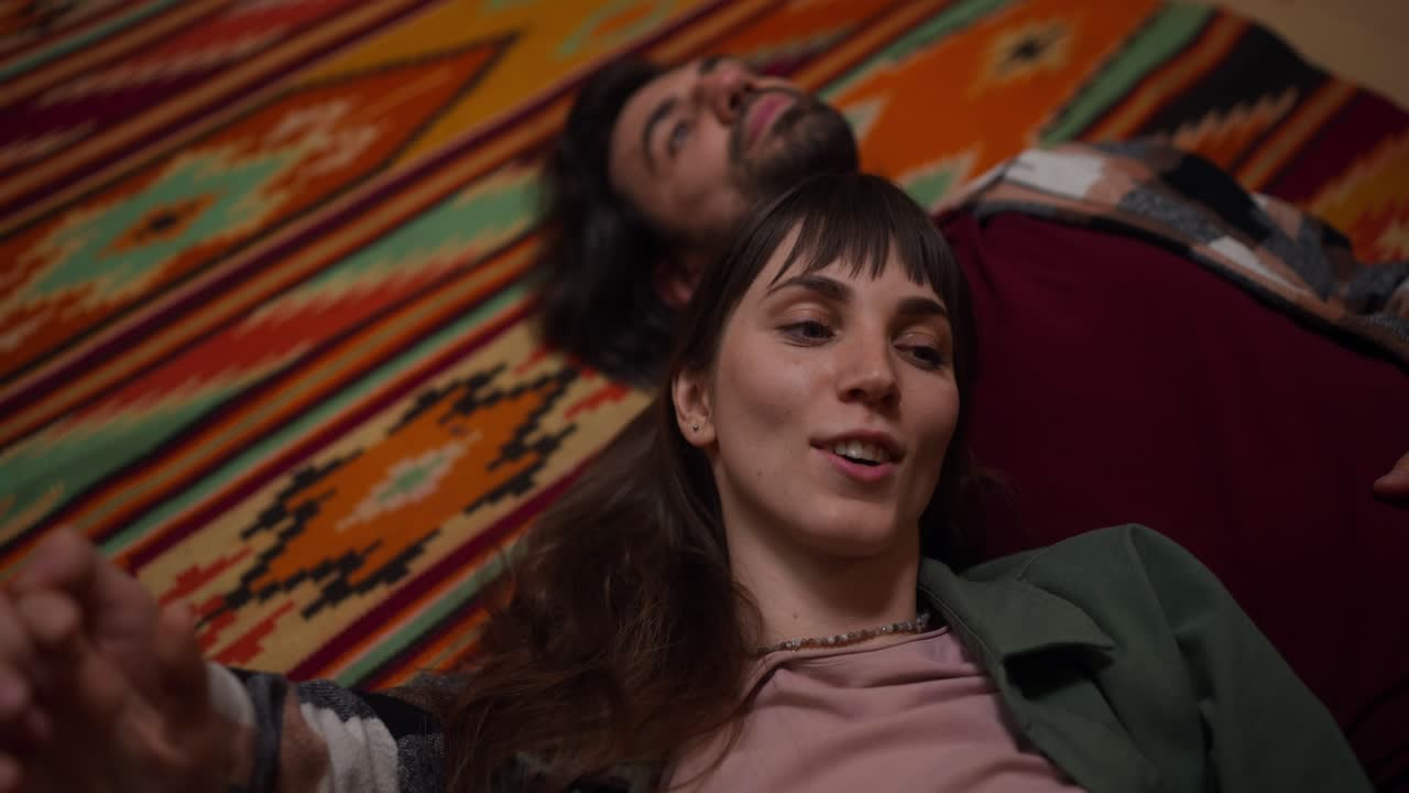 Couple lying on a colorful carpet