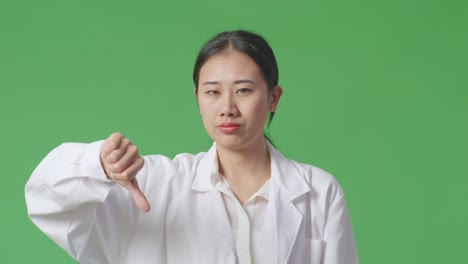 woman in lab coat giving thumbs down