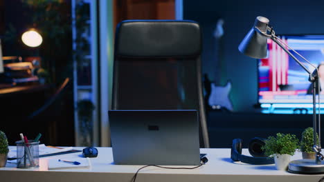 panning shot of personal office desk in front of smart tv displaying news