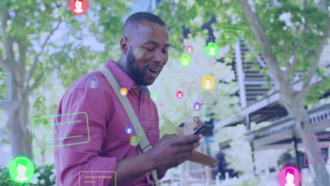 animation of social media reactions over happy african american man using smartphone and eating
