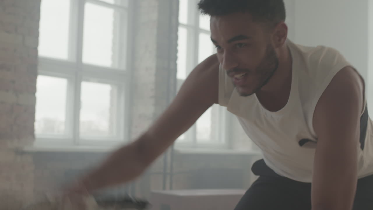 Determined Sportsman Training With Battle Rope