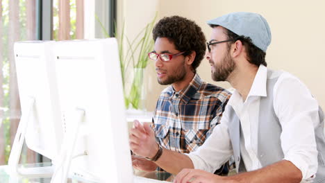 hipster smiling men using computer