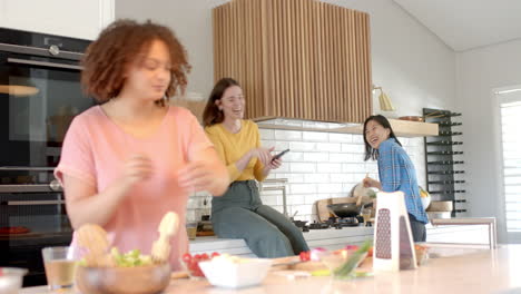 cooking together in kitchen, three women friends preparing food and enjoying conversation