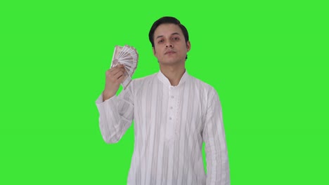 Indian-man-using-money-as-fan-in-attitude-Green-screen