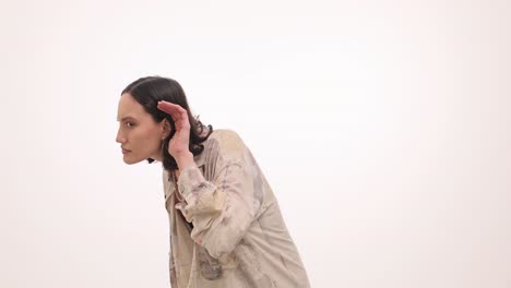 woman listening intently with hand to ear