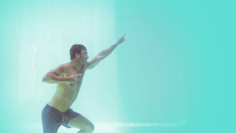 Handsome-man-swimming-underwater-