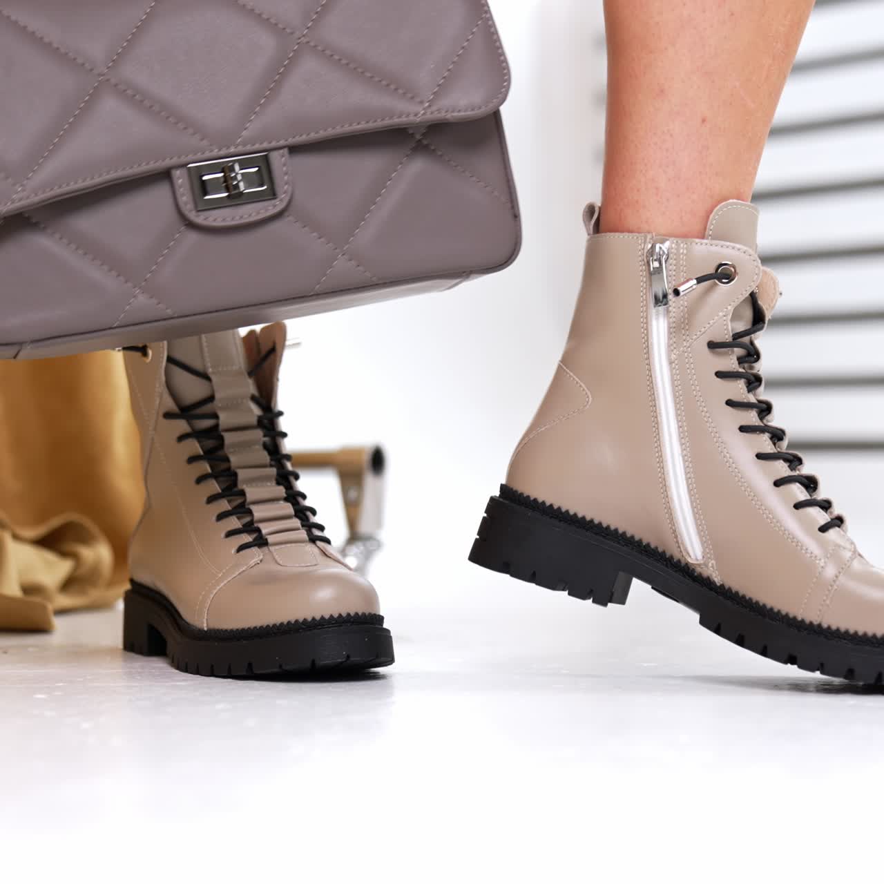 Stylish footwear trying out in shop. Fashionable boutique of woman shoes