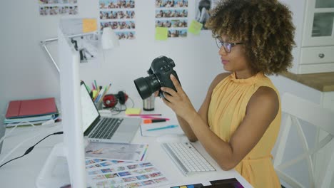 young woman exploring photos on camera