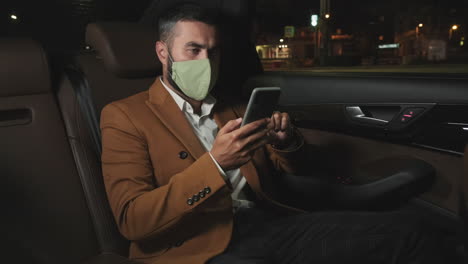 businessman in mask at backseat