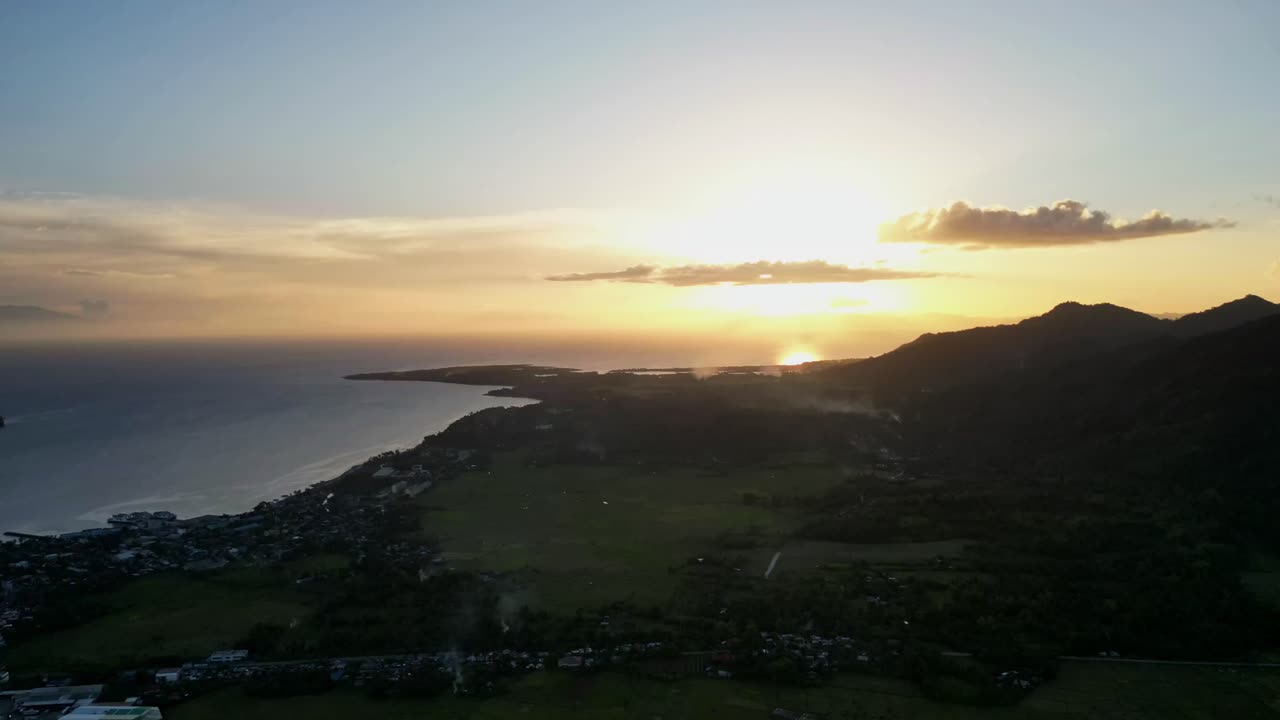 Stunning aerial time-lapse of sunset horizon with picturesque clouds atop tropical island setting - San Andres, Catanduanes, Philippines