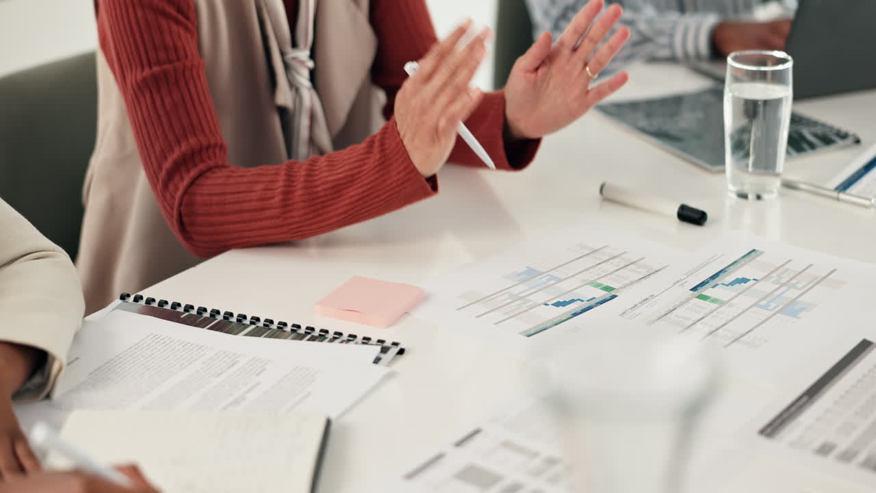 Business meeting with charts and documents