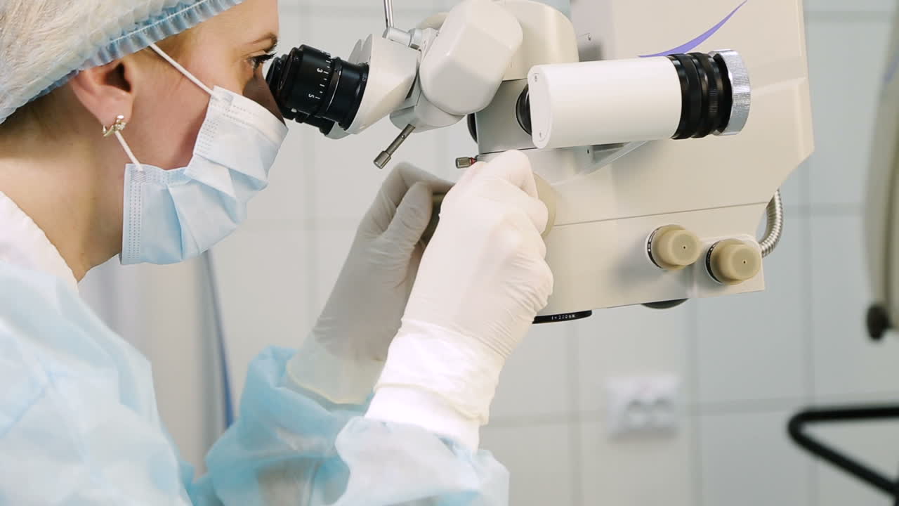Ophthalmology operation process. Surgeon with operating system of laser vision correction in the operating room
